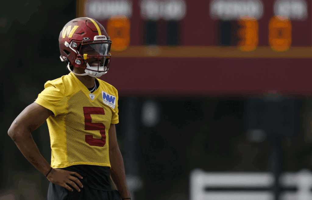 Jul 23, 2025; Ashburn, VA, USA; Washington Commanders quarterback Jayden Daniels (5) looks on during practice on day one of training camp at OrthoVirginia Training Center at Commanders Park. Mandatory Credit: Geoff Burke-Imagn Images