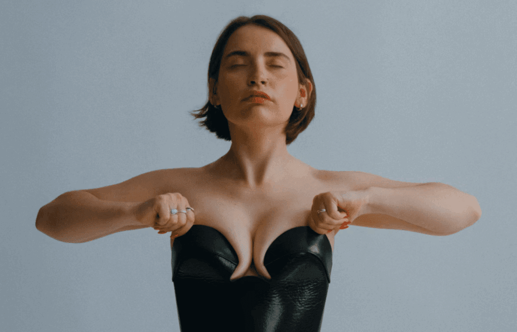 Woman in black tube top fixes posture