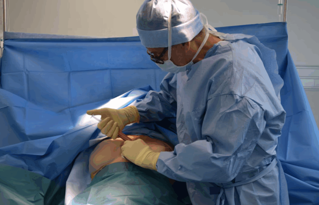 Surgeon performing breast surgery in operating room