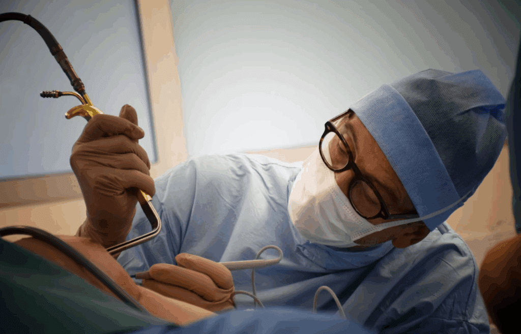 Woman undergoing breast augmentation in operating room