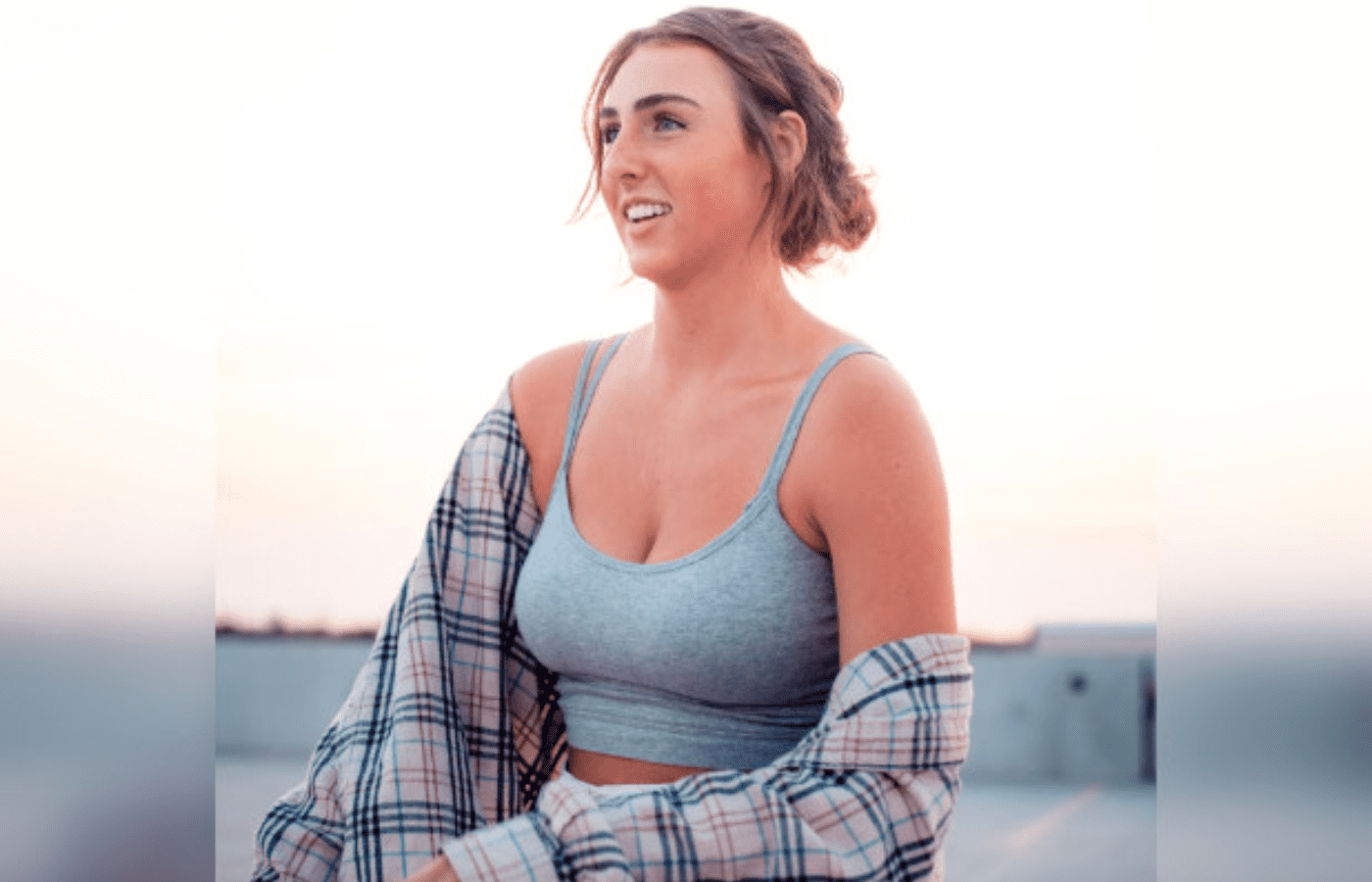 Confident smile on woman in gray tank top