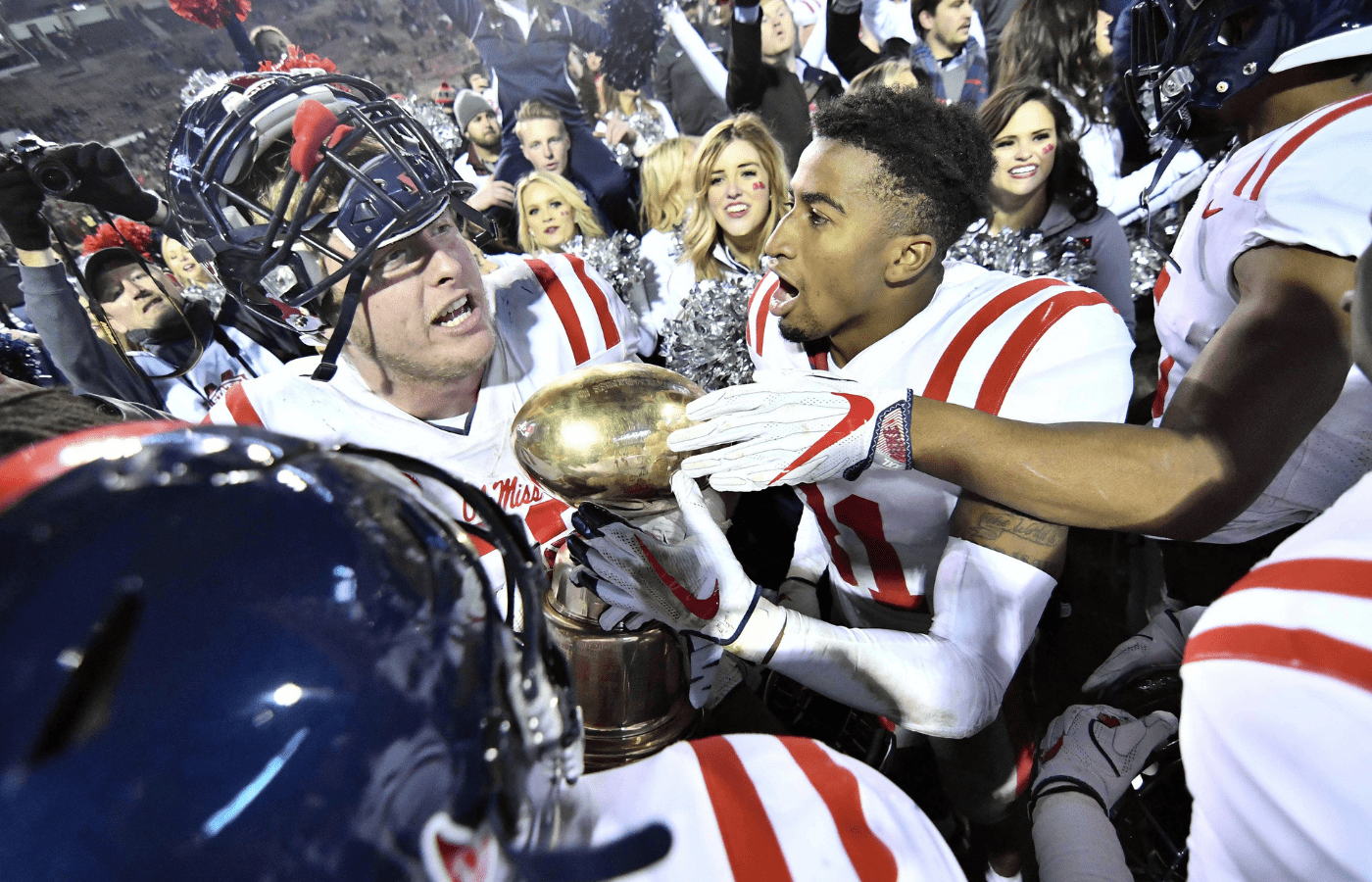 Nov 23, 2017; Starkville, MS, USA; Mississippi Rebels players celebrate after the game against Mississippi State Bulldogs at Davis Wade Stadium. Mandatory Credit: Matt Bush-Imagn Images