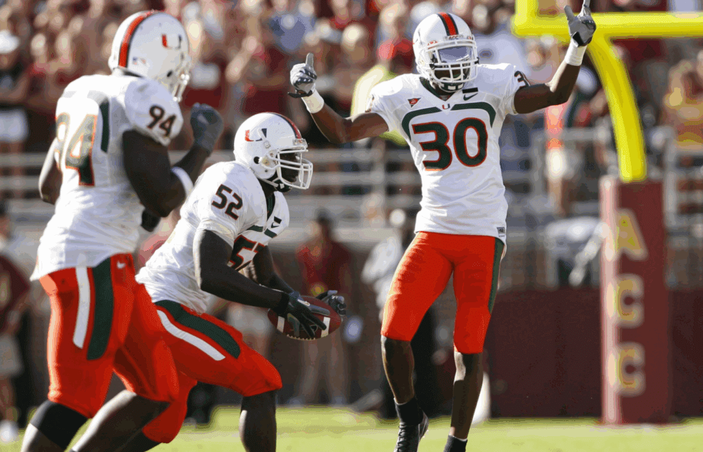 Oct 20, 2007; Tallahassee, FL, USA; Miami Hurricanes defensive back DeMarcus Van Dyke (30) and linebacker Tavares Gooden (52) celebrate after a fumble recovery against the Florida State Seminoles during the second quarter at Doak Campbell Stadium in Tallahassee, Florida. Miami won the game 37-29. Mandatory Credit: Jason Parkhurst-Imagn Images Copyright © Jason Parkhurst