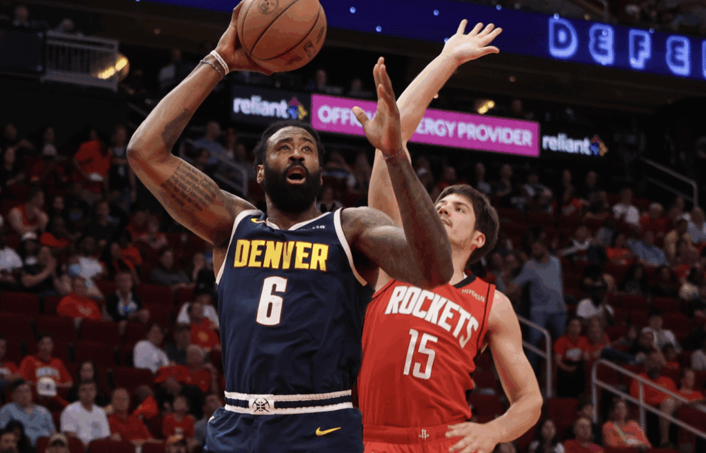 Apr 13, 2025; Houston, Texas, USA; Denver Nuggets center DeAndre Jordan (6) shoots against Houston Rockets guard Reed Sheppard (15) in the second half at Toyota Center. Mandatory Credit: Thomas Shea-Imagn Images