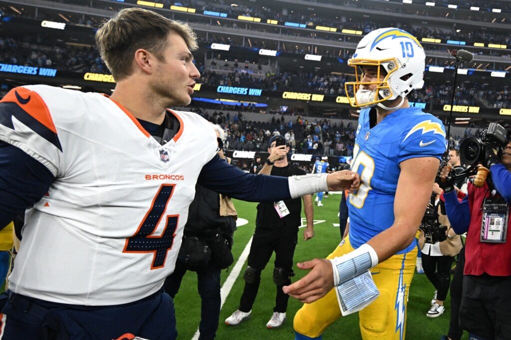 Dec 19, 2024; Inglewood, California, USA;  Los Angeles Chargers quarterback Justin Herbert (10) is congratulated by Denver Broncos quarterback Zach Wilson (4) following the game at SoFi Stadium. Mandatory Credit: Jayne Kamin-Oncea-Imagn Images